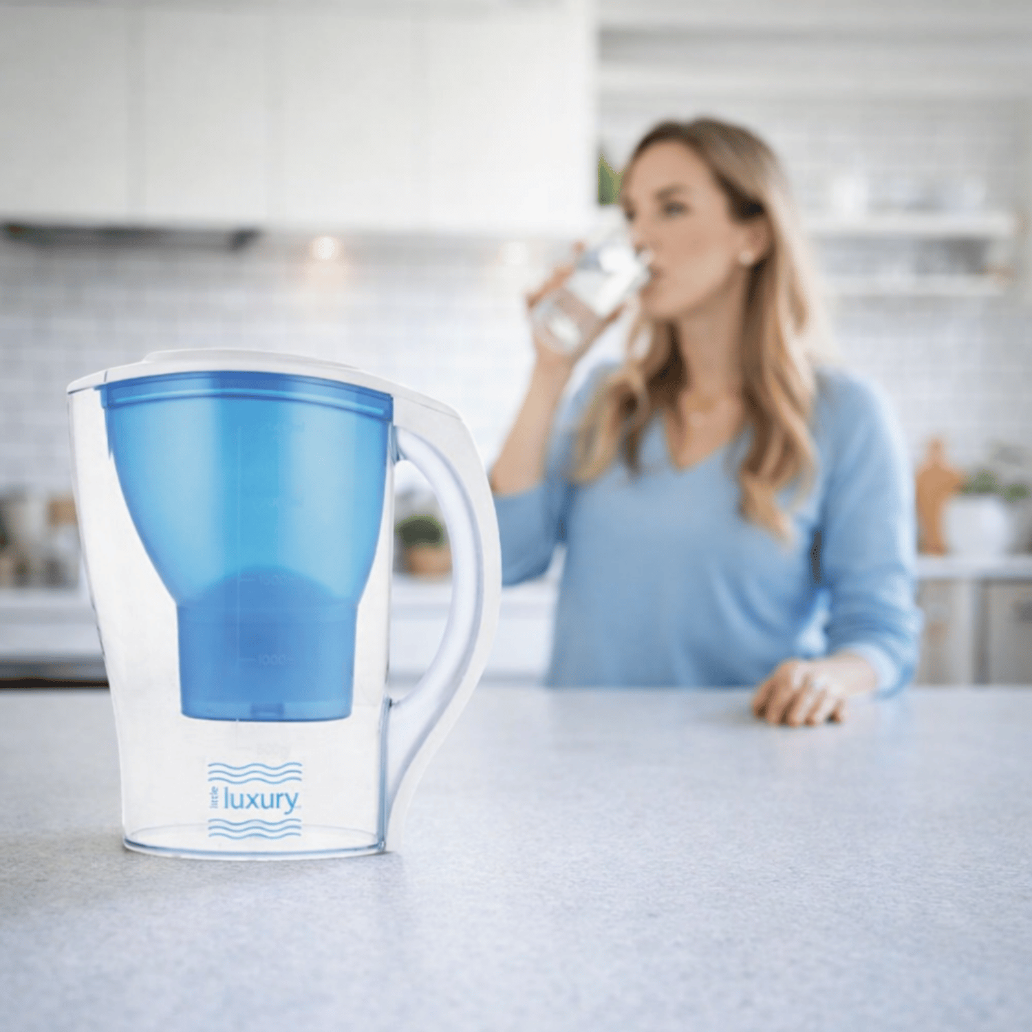 Little Luxury Hawaiian Water Filter Jug on kitchen counter with woman drinking water