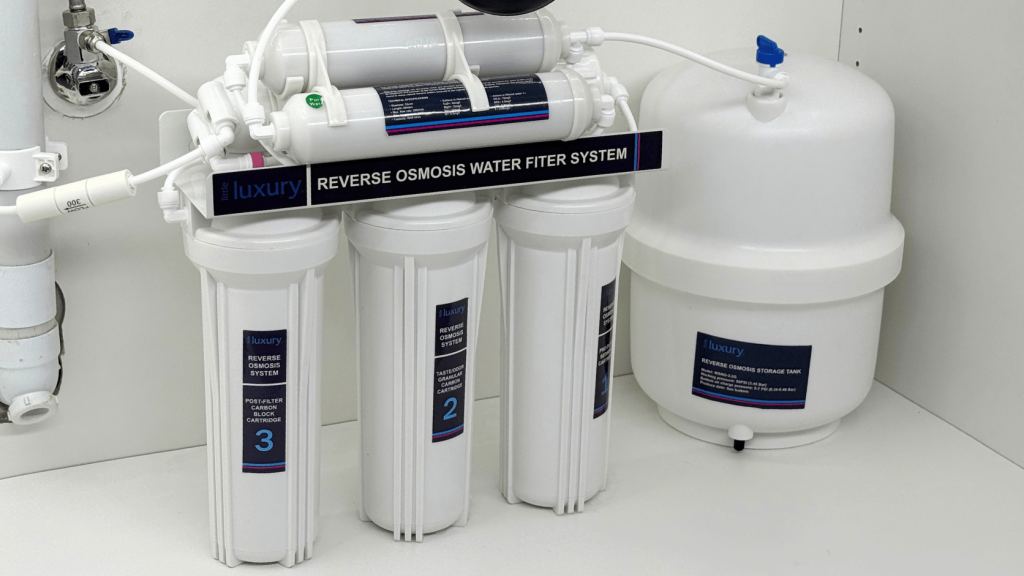 Under-sink water filtration system installed in a modern kitchen cabinet.